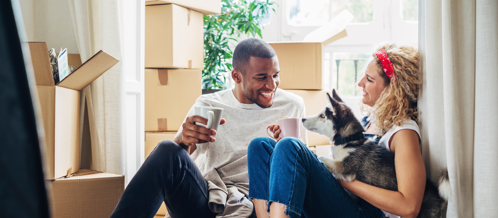 Couple sitting on the floor with their dog