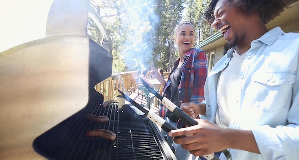 Happy couple grilling and laughing