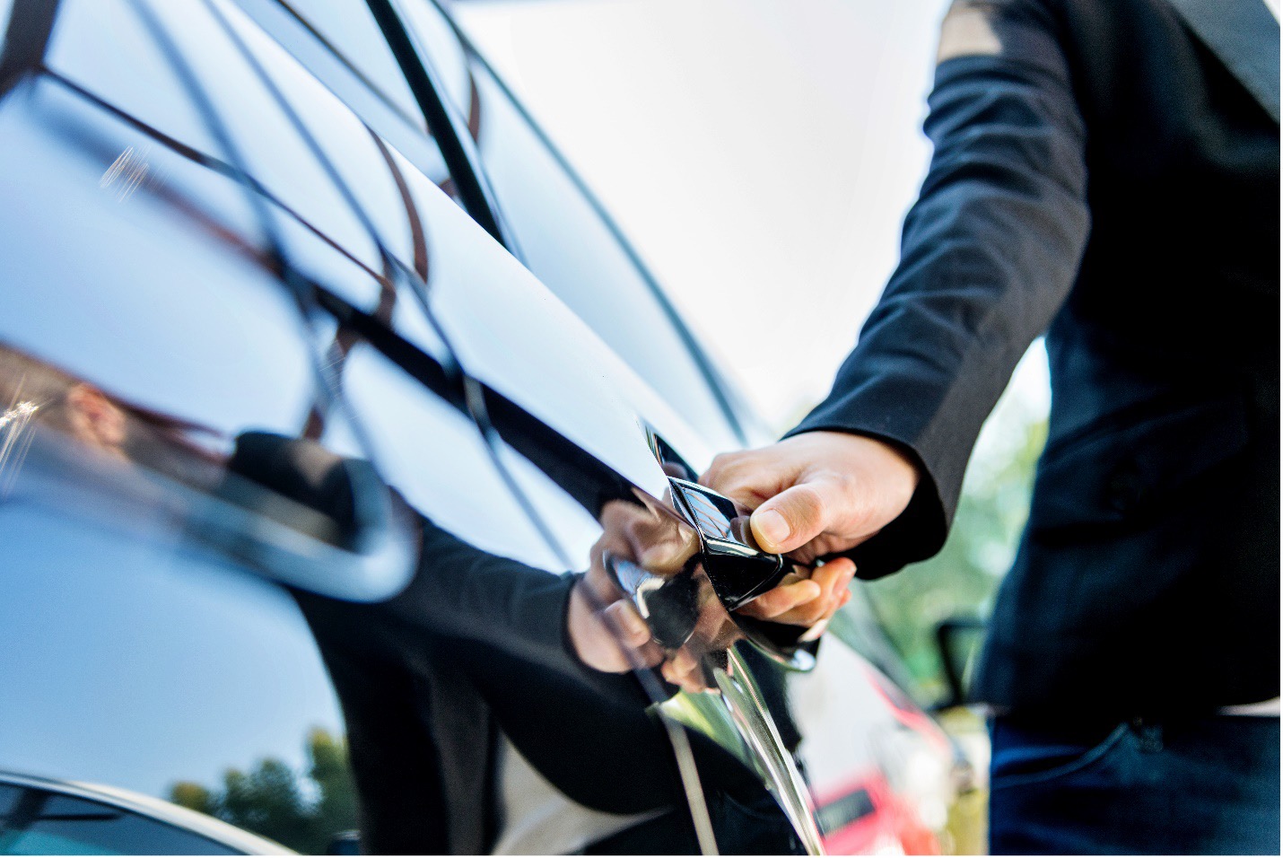 Man holding door of luxury car
